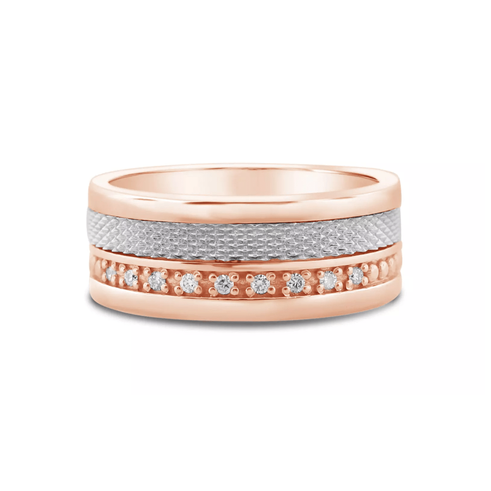 A rose gold wedding band that is thick and has lots of diamonds going around it.