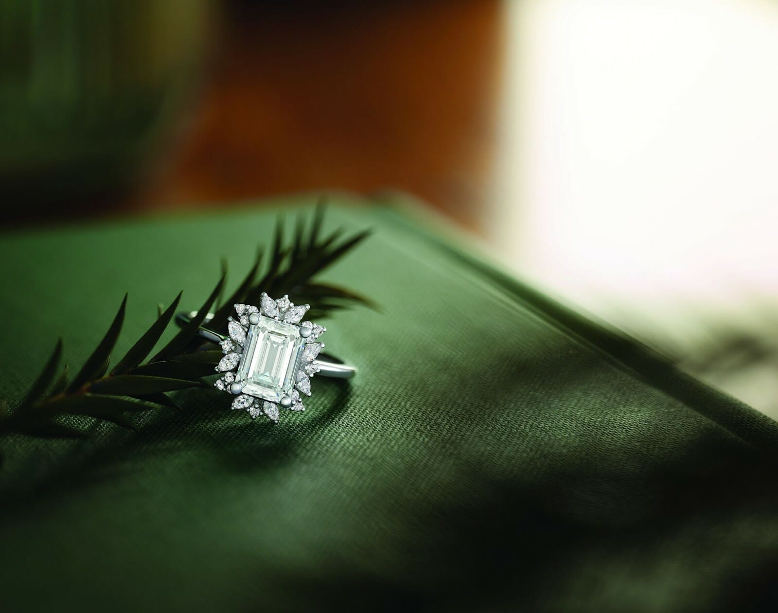 A stunning ADX holiday jewellery gift diamond ring on a green holiday themed surface.