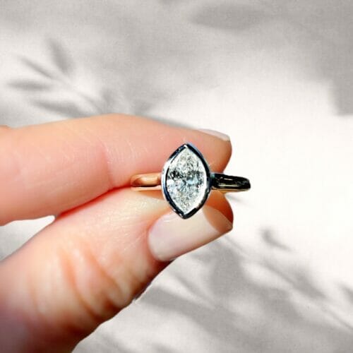 A stunning bezel setting with a beautiful ADX diamond being held.