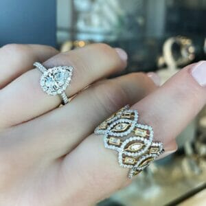 Two white gold rings being shown off on a models hand.