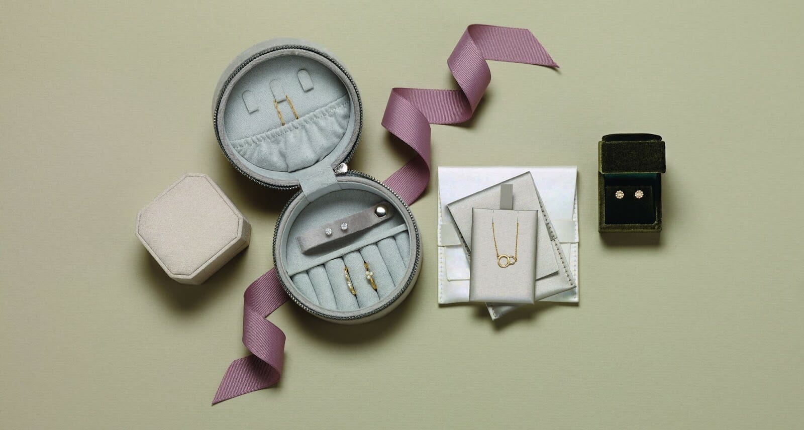 Several pieces of jewellery organised into a carrying case made for travelling with jewellery.