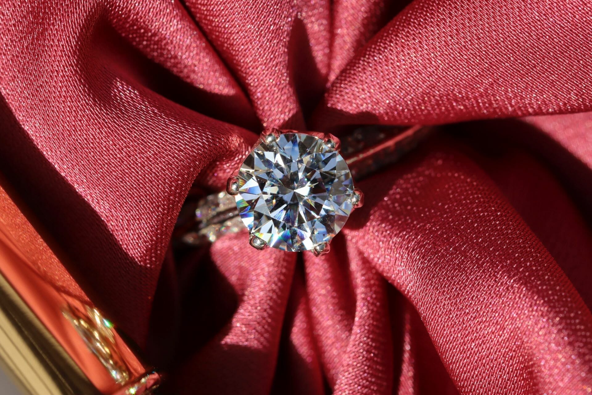 A beautiful conflict-free diamond ring wrapped in a red cloth.